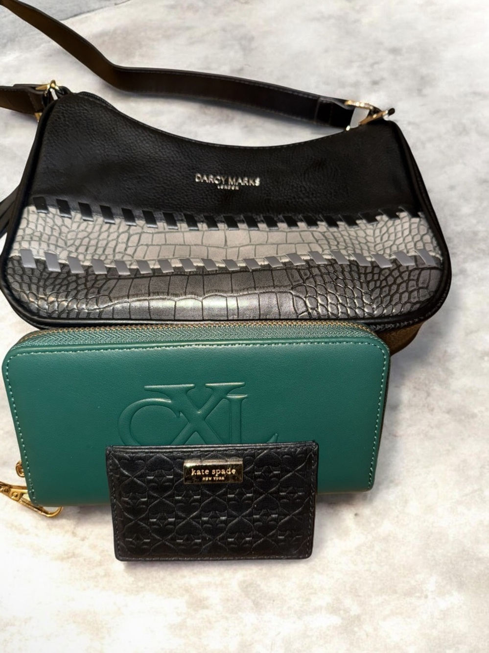 Dare to Marks crossbody, green CX wallet, and black Kate spade card holder